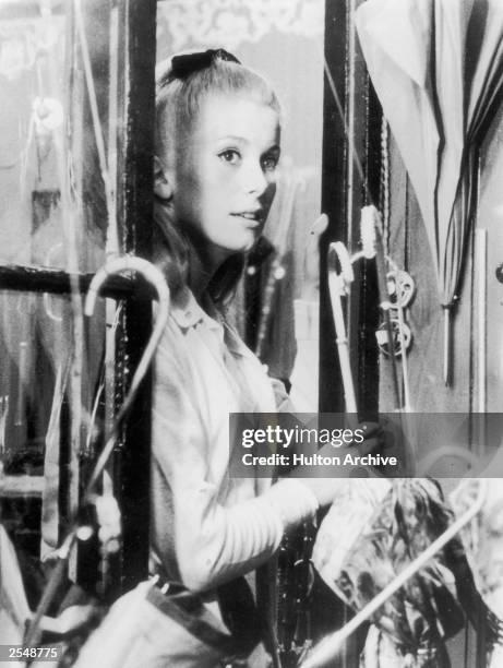 French actress Catherine Deneuve in a still from Jacques Demy's film 'Parapluies de Cherbourg', also known as 'Umbrellas of Cherbourg', 15th May 1964.