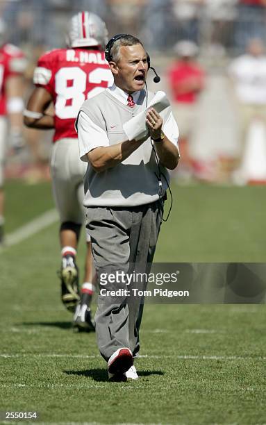 Coach Jim Tressel of the Ohio State University Buckeyes cheers for his team after they scored a touchdown against the Bowling Green State University...