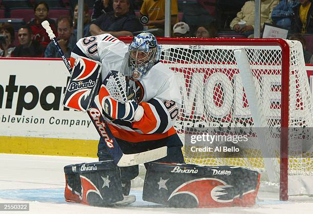 Garth Snow of the New York Islanders makes a save against the New Jersey Devils on September 24, 2003 at the Continental Airlines Arena in East...