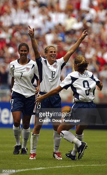 Midfielder Kristine Lilly of the United States celebrates her first period goal as she is joined by teammates forward Mia Hamm and midfielder Shannon...