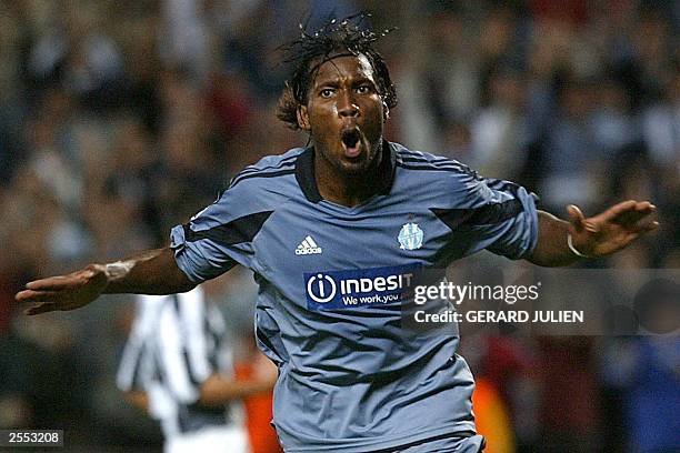Marseille's forward Didier Drogba jubilates after scoring a goal during during the Champions League soccer match opposing Olympique de Marseille to...
