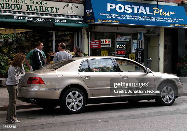 New 2004 Volkswagen Phaeton luxury sedan, not yet available in the U.S., is parked on a street for a print advertisement photo shoot October 1, 2003...