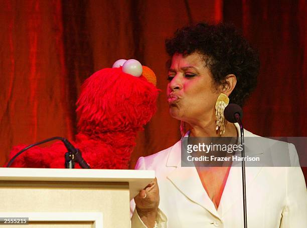 Actress Debbie Allen kisses Elmo a Sesame Street character on stage at The Producers Guild of America 2nd Annual Celebration of Diversity Awards held...
