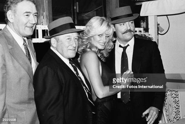 American city councilman John Ferraro, author Mickey Spillane, and actors Randi Brooks and Stacy Keach pose together as they celebrate 'Mickey...