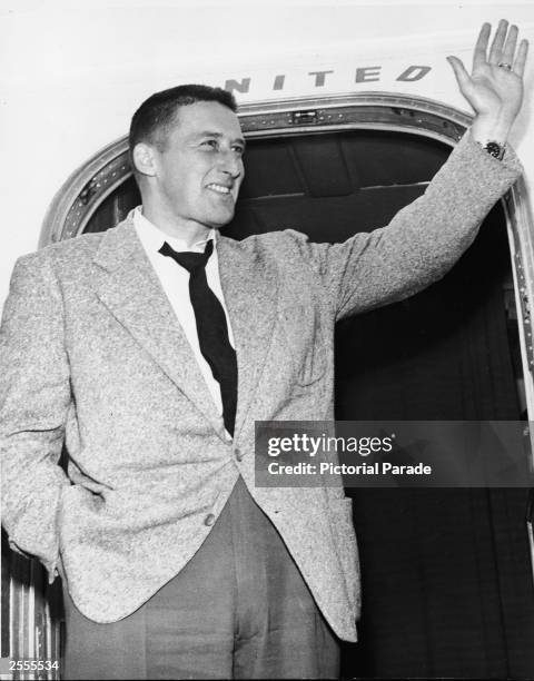 American crime writer Mickey Spillane (Frank Morrison Spillane waves from the door of an airplane upon arrival at the airport, Los Angeles,...