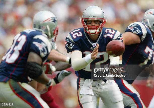 Quarterback Tom Brady of the New England Patriots pitches back to Kevin Faulk during the game against the Washington Redskins on September 28, 2003...