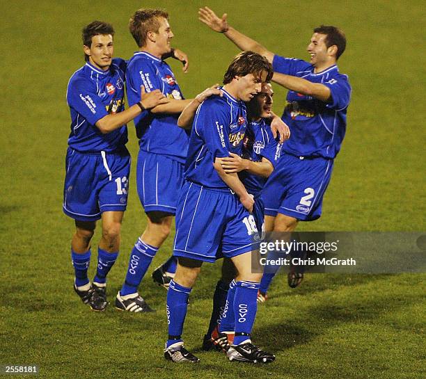 Michael Curcija of South Melbourne is congratulated by team mates after scoring a goal during the NSL round 3 match between the Wollongong Wolves and...