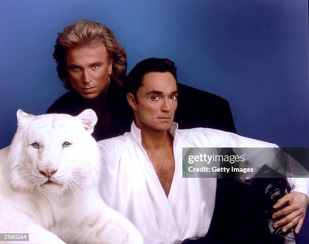 In this handout image provided by the Mirage Resort, Siegfried & Roy pose with a white tiger in this undated photo. Horn, 59-years-old, was mauled...