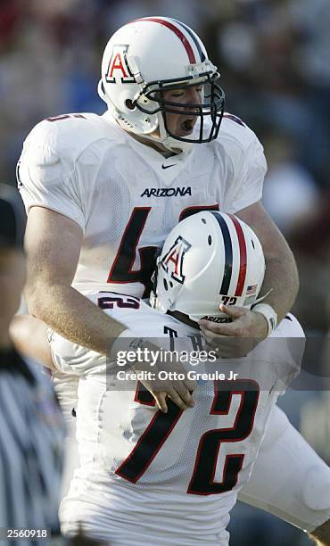 Tight End Matt Padron of the University of Arizona Wildcats celebrates with teammate Tanner Bell after scoring a touchdown against the Washington...