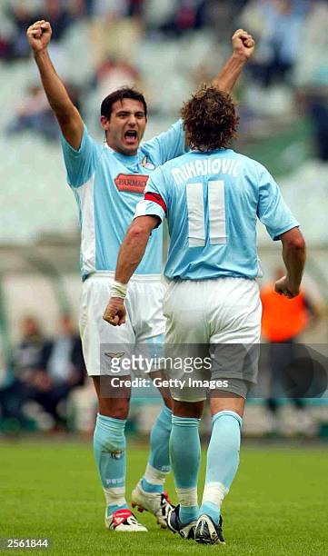 Sinisa Mihajlovic of Lazio celebrates with a team-mate after scoring during the Serie A match between Lazio and Chievo at the Olympic Stadium October...
