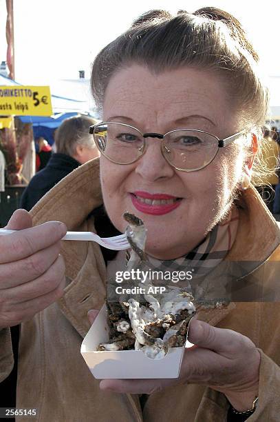 Marjo Kalliomaeki was one of over ten thousand locals visiting the Finnish capital's 261st annual Baltic Herring Market 05 October 2003. Here she...