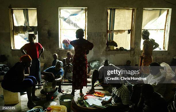 Refugees crowd into a Masonic temple converted into a camp July 15, 2003 in the Liberian capital of Monrovia. Hundreds of thousands of Liberians have...