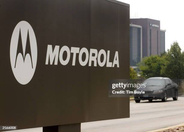 Car drives past a sign for Motorola's campus August 12, 2002 in Schaumburg, Illinois. Motorola Chairman and CEO Christopher Galvin announced October...