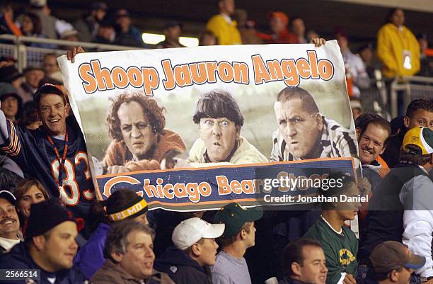 Fans of the Chicago Bears hold up a Three Stooges sign to show their unhappiness with the performance of offensive coordinator John Shoop as Larry...