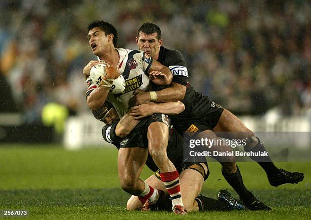 Craig Wing of the Roosters is tackled by Scott Sattler and Martin Lang of the Panthers during the NRL Grand Final between the Sydney Roosters and the...