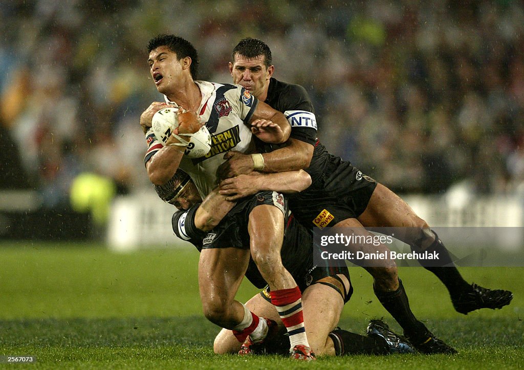 Craig Wing is tackled by Scott Sattler and Martin Lang