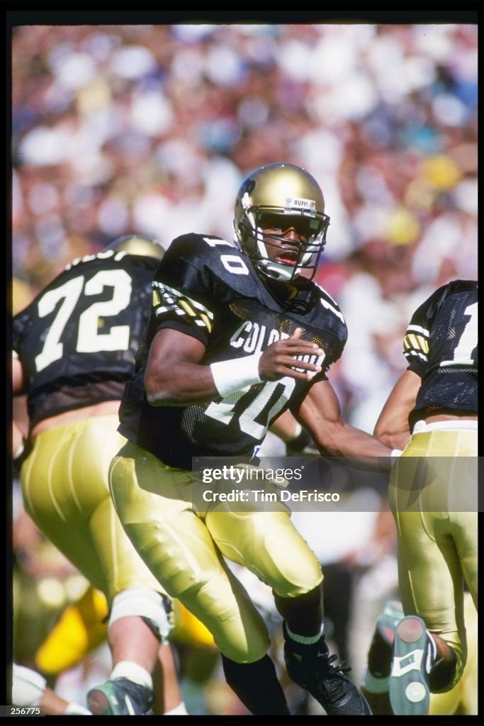 Quarterback Kordell Stewart of the Colorado Buffaloes hands off the