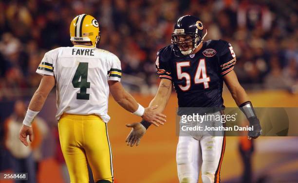 Quarterback Brett Favre of the Green Bay Packers congratulates linebacker Brian Urlacher of the Chicago Bears on September 29, 2003 at Soldier Field...