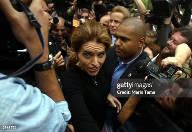 Maria Shriver, wife of Republican gubernatorial candidate Arnold Schwarzenegger, fights her way through a crowd of media after casting his ballot in...