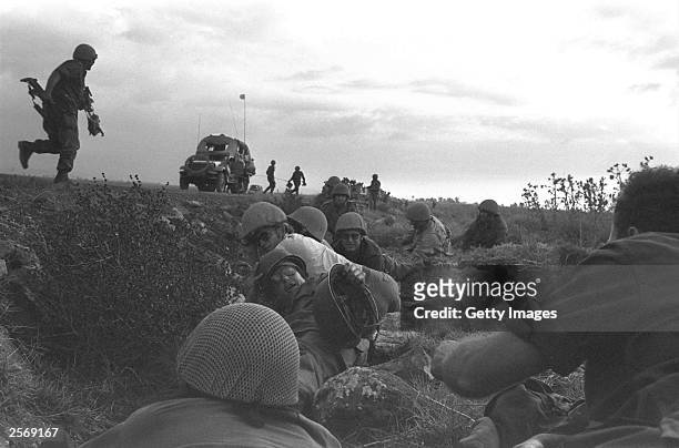 Israeli troops dive for cover as Syrian warplanes strafe their column October 8, 1973 on the Golan Heights, two days into the Yom Kippur War. Israeli...