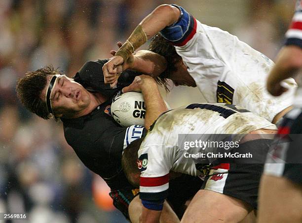 Martin Lang of the Panthers is smashed by the Roosters defence during the NRL Grand Final between the Sydney Roosters and the Penrith Panthers at...