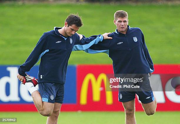 Frank Lampard and Steven Gerrard of England warm up during England's training session at the Colney Hatch training ground on October 8, 2003 in St...