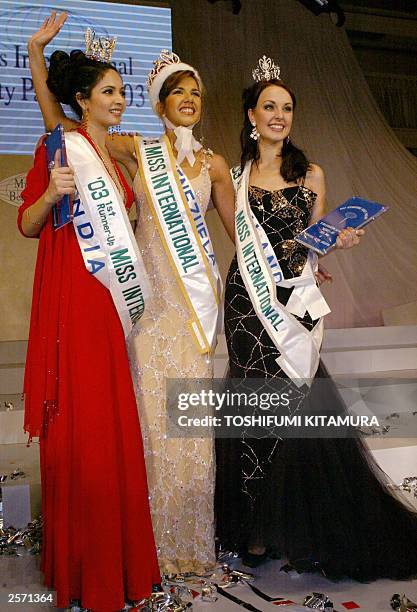 Newly crowned Miss International, 19-year-old Miss Venezuela Goizeder Azua waves while posing with first runner-up Miss India Shonali Nagrani and...