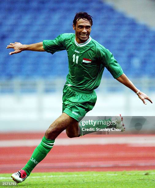 Jassim S. Fayadh of Iraq celebrates after scoring the first goal during the match between Iraq and Bahrain during the Group F Asian Cup qualifier...