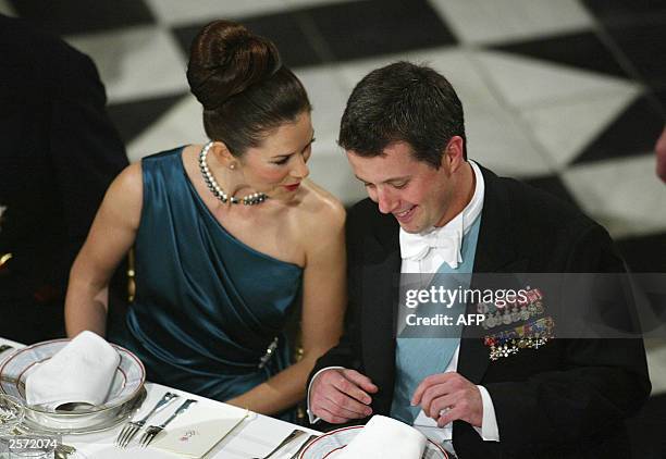 Australian Mary Donaldson talks with her fiance Danish Crown Prince Frederik, 08 October 2003, during the extended State Council galla dinner at the...