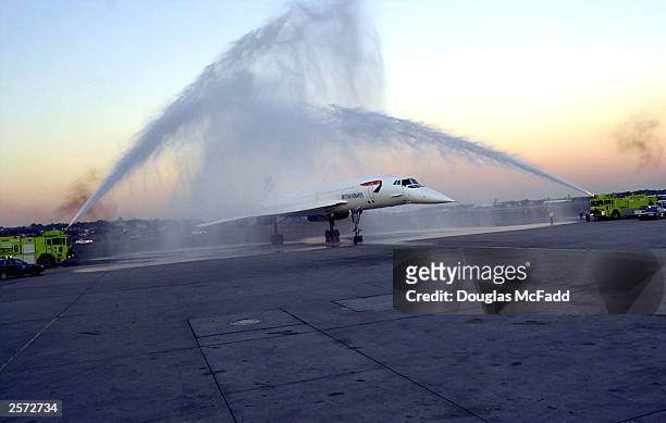 British Airways Concorde Flight 1215 passes through a water display provided by the Massport Fire Rescue Department after arriving at Logan...
