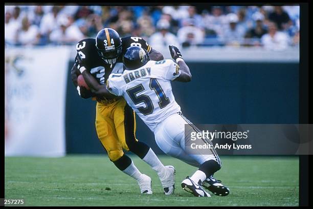 Running back Tim Lester of the Pittsburgh Steelers runs into the arms of linebacker Kevin Hardy of the Jacksonville Jaguars during the Steelers 24-9...