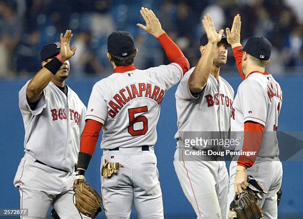 The Boston Red Sox celebrate after defeating the New York Yankees 5-2 in game 1 of the American League Championship Series on October 8, 2003 at...