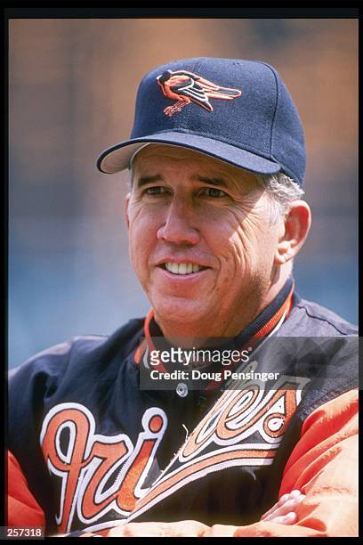 Manager Davey Johnson of the Baltimore Orioles stands on the field watching his players during a game against the Texas Rangers at Camden Yards in...