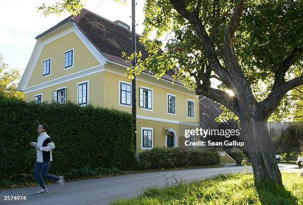 Young woman jogs past the childhood home of newly-elected California Governor Arnold Schwarzenegger October 9, 2003 in the village of Thal, Austria....