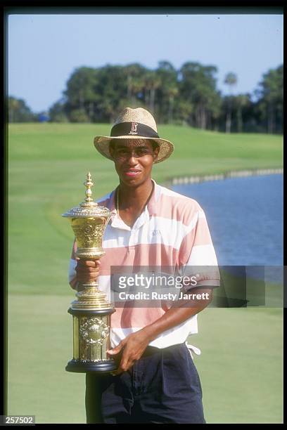 Tiger Woods holds the trophy of victory after completing the U.S. Amateur Championship tournament at the TPC at Sawgrass in Ponte Vedra Beach,...