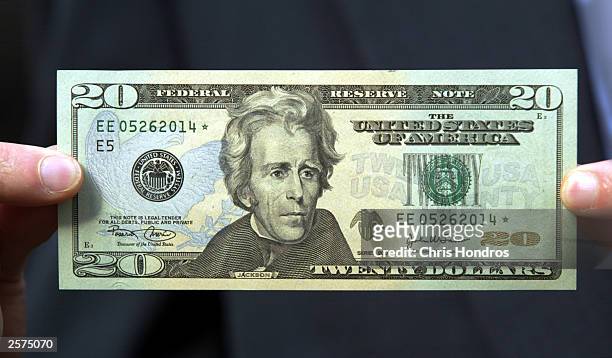 The new design for the twenty dollar bill is held by a man October 9, 2003 in New York City. The new currency includes improved security features and...