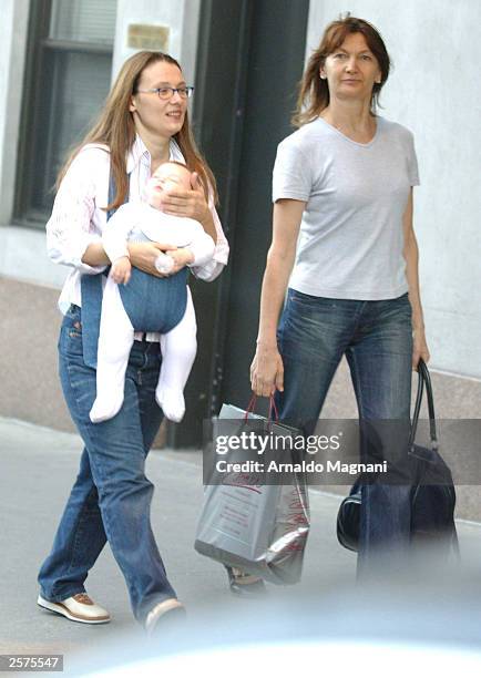 Nicoletta Mantovani, companion of opera singer Luciano Pavoritti, and their daughter Alice walk on Central Park South September 23, 2003 in New York...