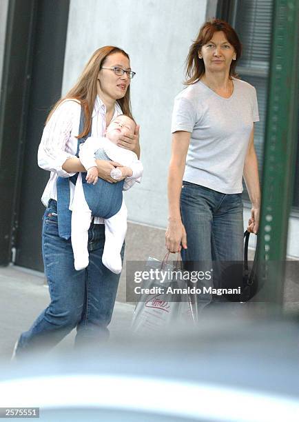Nicoletta Mantovani, companion of opera singer Luciano Pavoritti, and their daughter Alice walk on Central Park South September 23, 2003 in New York...