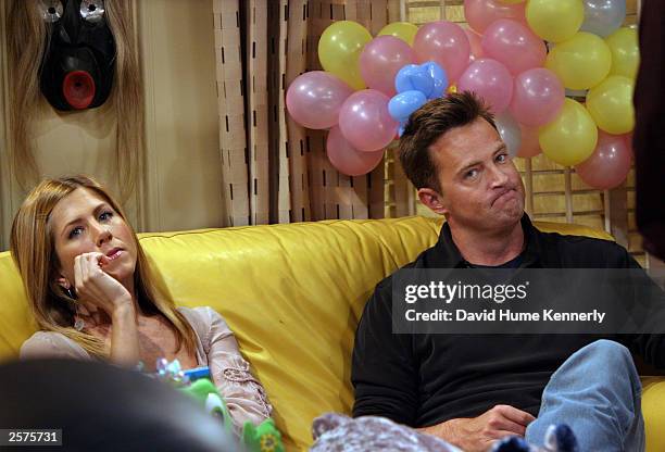 Matthew Perry and Jennifer Aniston take a break during the filming of the hit NBC series "Friends," on the Warner Bros lot Sept. 12, 2003 in Burbank,...