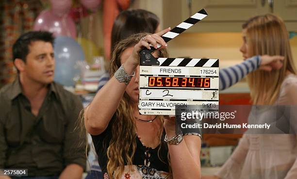 Cast members Matt LeBlanc, Courteney Cox, and Jennifer Aniston prepare to shoot a scene of their hit NBC series "Friends" during one of their last...