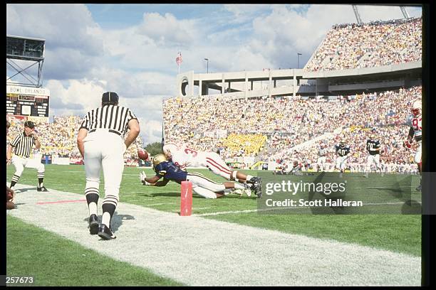 Split end Emmett Merchant of the Georgia Tech Yellow Jackets dives for the ball during a game against the Nebraska Cornhuskers at the Citrus Bowl in...