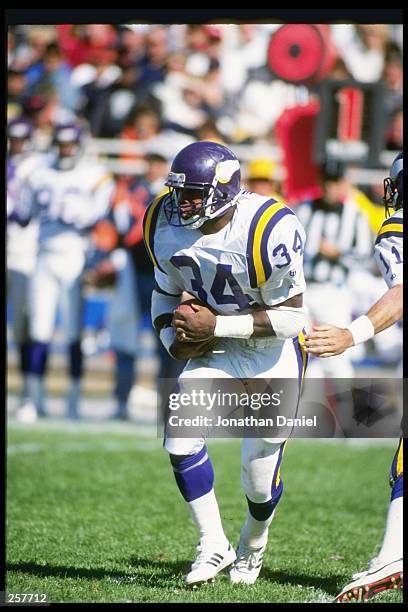 Running back Herschel Walker of the Minnesota Vikings moves the ball during a game against the Chicago Bears at Soldier Field in Chicago, Illinois....