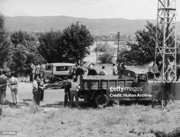 The bodies of Sir Jack Drummond, Lady Drummond and their 10 year-old daughter Elizabeth are removed from the roadside near Digne in Southern France,...
