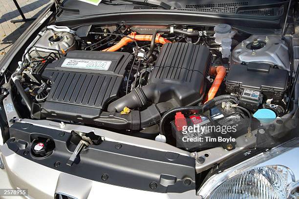 The engine area is visible on a new Honda Civic Hybrid automobile during an exposition at the Motorola campus October 10, 2003 in Deer Park,...