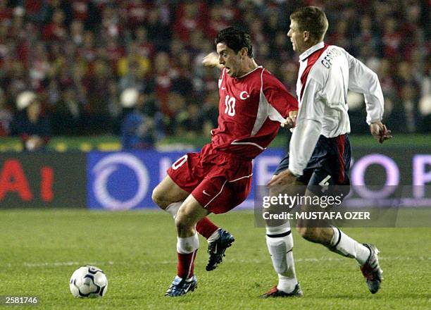 England`s Steven Gerrard fights for the control of the ball with Turkey`s Nihat Kahveci during their Euro 2004 qualifying match at the Sukru...
