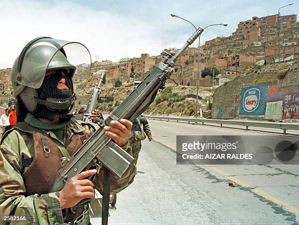 Members of the Bolivian Army keep watch over the main road to the airport in El Alto, downtown La Paz, after some demonstrators tried to take it 11...