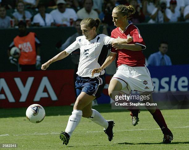 Tiffeny Milbrett of USA is chased down by Brittany Timko of Canada during the third place match of the FIFA Women's World Cup on October 11, 2003 at...