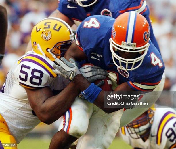 Ciatrick Fason of Florida Gators is tackled by Lionel Turner of the Louisiana State University Tigers on October 11, 2003 at Tiger Stadium in Baton...