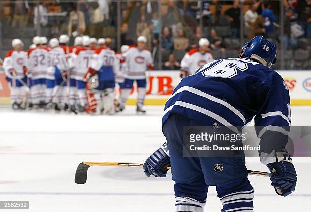 Darcy Tucker of the Toronto Maple Leafs hangs his head as he glances down ice to see members of the Montreal Canadiens celebrate their 4-0 win during...
