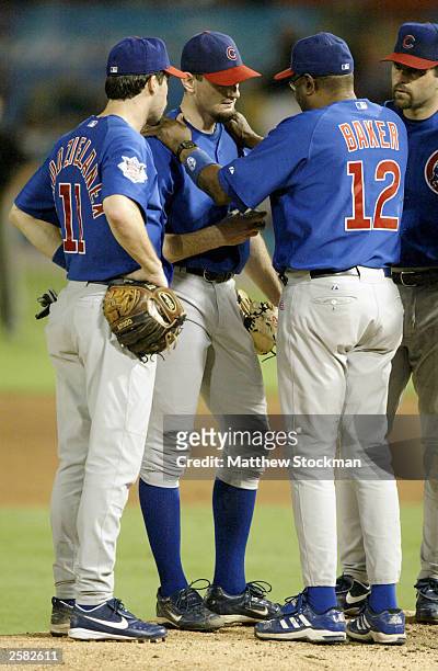 Manager Dusty Baker of the Chicago Cubs talks with starting pitcher Matt Clement before pulling him from the game against the Florida Marlins in game...